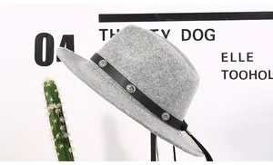 Detail of wool fedora hat with black leather band and embossed silver metal buckles