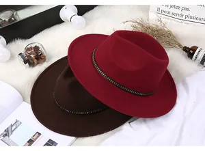 Detail of wool fedora hats with metal studded belts in burgundy and dark coffee brown