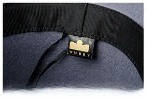 Detail of internal sweatband and gold brand logo label inside the dark grey wool fedora