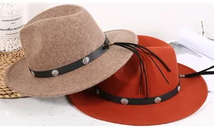 Detail of wool fedora hats with vintage silver buckles and leather tassels