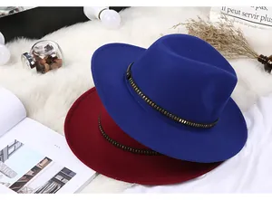 Flat lay of wool fedora hats in blue and burgundy with decorative metal studded bands