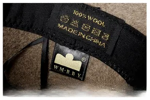 Close-up of 100% wool felt hat interior featuring branded logo and care label detail