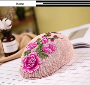 Close-up of pink mesh beret featuring detailed 3D rose flower embroidery and leaf texture