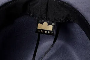 Macro detail of wool fedora hat interior with premium sweatband and golden woven logo
