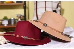 Close-up of wool fedora hats with stylish leather bands and sunflower metal buckles