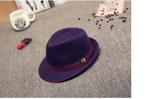 Close-up of purple mesh fedora with dark red band and vintage metal emblem detail