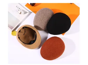 Detail view of winter wool blend beret hats in black, grey, camel and caramel colors