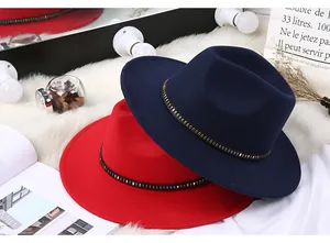 Detail of wool felt fedora hats in red and navy blue with metal rivet decorative bands