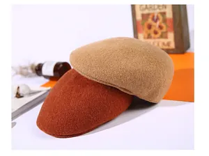 Flat lay of camel and caramel wool beret hats with vintage props for winter style