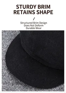 Detail of a black cashmere flat cap featuring a wide, sturdy and reinforced brim