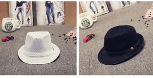 Close-up of summer mesh fedora hats with metal badge detail in white and black