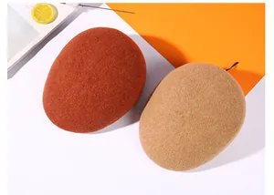 Detailed texture of caramel and beige wool beret hats for winter fashion