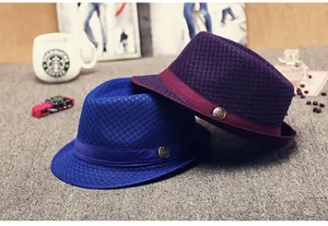 Close-up of mesh fedora hats in royal blue and purple with ribbon and metal accents