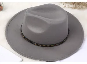 Detail of grey wool fedora hat with black leather belt and gold studded accents