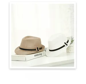 Detail of classic fedora hats in light brown and white with black ribbon bands