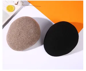 Close-up of wool texture on brown and black winter newsboy caps for men and women