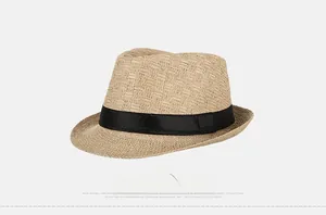 Side view detail of a beige straw fedora hat featuring a classic black ribbon band
