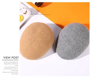 Winter wool felt beret hats in khaki and gray shown with stylish magazine decor