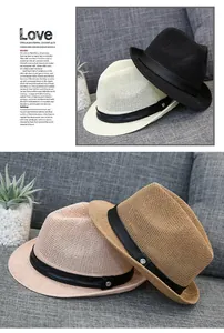 Detailed weave texture of four stylish straw fedora hats with leather buckled bands