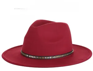 Detail of wine red wool fedora hat featuring a black leather belt with metal studs