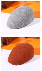 Detailed texture of thick wool felt beret hats in light grey and caramel colors
