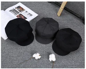 Flat lay of retro wool newsboy caps in black and dark grey colors for winter season