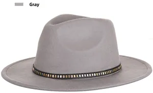 Detail of gray wool fedora hat featuring a black band with gold and silver metal studs