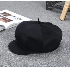 Detailed close-up of a black cashmere newsboy cap for men with premium wool texture