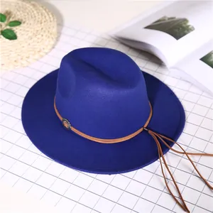 Navy blue wide brim wool fedora hat with brown leather band and vintage metal badge