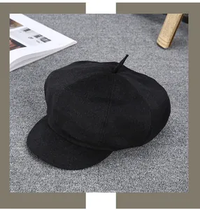 Top view of a vintage black cashmere newsboy cap with wool texture on a stylish background