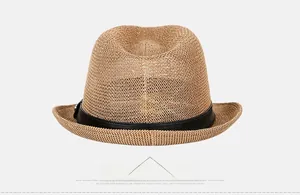 Close-up of brown straw fedora featuring a black leather band and woven texture
