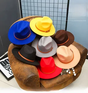 Stack of elegant wide brim wool fedora hats in seven colors on a leather chair