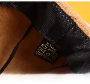 Detail of wool cap interior showing widened sweatband and 90% wool material label