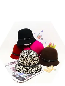 Detail of wool cloche hats with leopard print and buckle strap in various colors
