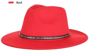 Detail of red wool fedora with a black faux leather band featuring metal studs