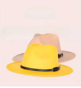 Detail of wide brim fedora hats in yellow and beige with black leather bands