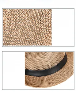 Detail of breathable paper straw weave and stylish black decorative band on sun hat