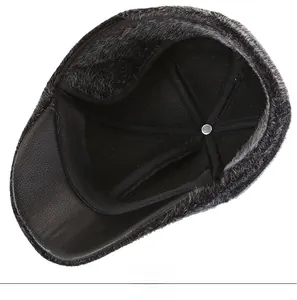 Detail view of winter flat cap with thick grey faux fur lining and premium leather brim