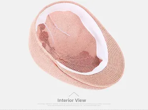 Internal view of pink woven beret showing white sweatband and adjustable windproof rope
