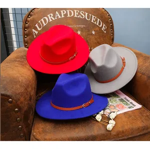 Detail of wool fedora hats in red, blue, and gray with brown leather buckle straps