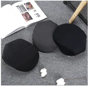 Black and dark grey wool newsboy caps in a classic stack with premium textured finish
