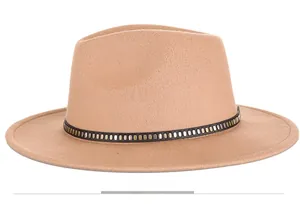 Side view detail of camel wool fedora hat featuring a black band and gold buckle