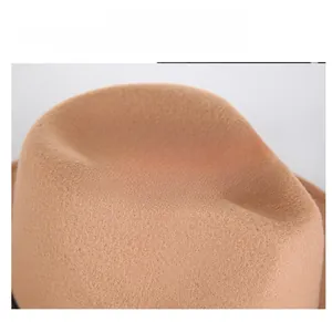 Close-up of brown wool felt fedora crown showing classic dent design and fabric texture