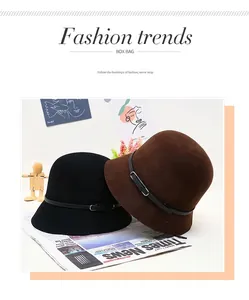 Close-up of wool felt bucket hats in black and brown with leather belts and metal buckles