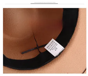 Detail view of brown felt fedora inner band with size 57 label and 65% polyester material
