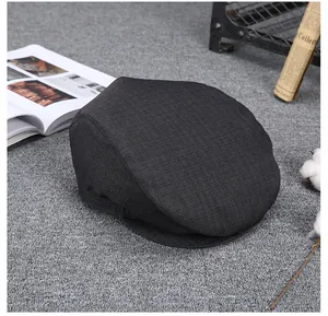 Close-up of deep gray newsboy cap showing detailed twill fabric texture and retro style