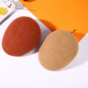 Thick wool beret in rust red and khaki colors shown from an overhead perspective