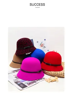Detail view of winter wool felt cloche hats in multiple colors with stylish leather belts