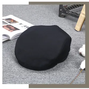 Detailed close-up of a black cashmere newsboy cap on a retro textured background