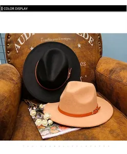 Detail of wool fedora hats in black and khaki with leather bands on a vintage chair